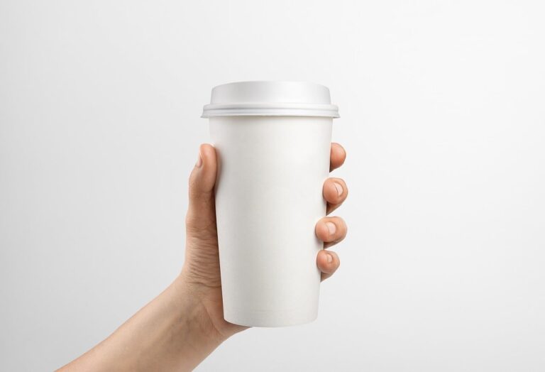 holding, paper cup, coffee cup, takeaway cup, disposable cup, reusable cup, blank cup, mockup, white cup, minimalist, pastel background, beverage, drink container, eco friendly, sustainable, zero waste, recycling, earth day, environmental, product mockup, hand holding cup, copy space, template, cafe, biodegradable